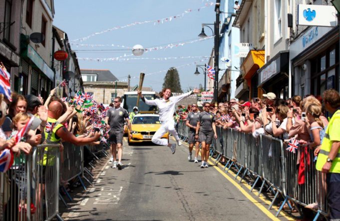 Dutch synchrone swimming coach Nadine Struijk carrying the Olympic Flame during the torch relay through Wales - May 2012